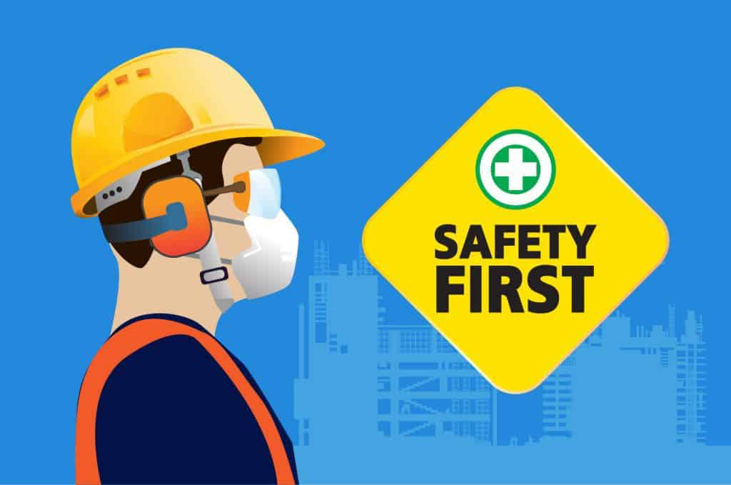 Safety First, construction worker wearing helmet, ear defenders and mask